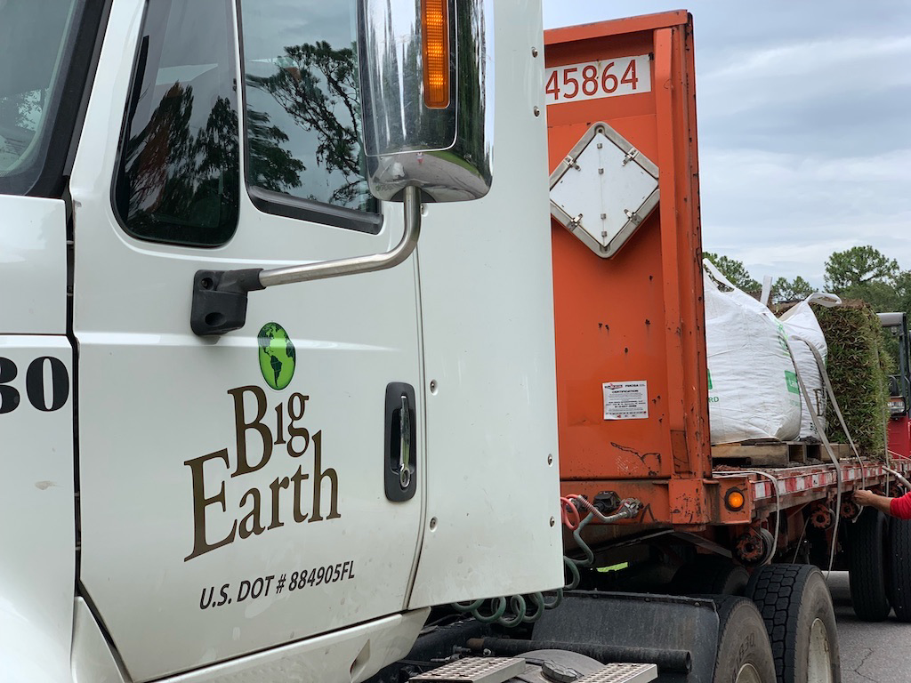 Big Earth Flatbed Semi delivering bulk products in super sacks near me